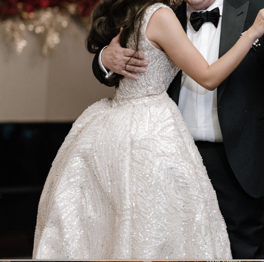 C2023-SD861 - sleeveless open neck line wedding gown with a beaded detachable train
