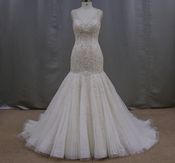 Sleeveless beaded wedding dresses with a v-neck line Darius Couture Sleeveless beaded wedding dresses with a v-neck line Darius Couture