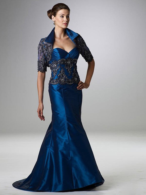 Blue formal gown with an intricately beaded matching jacket