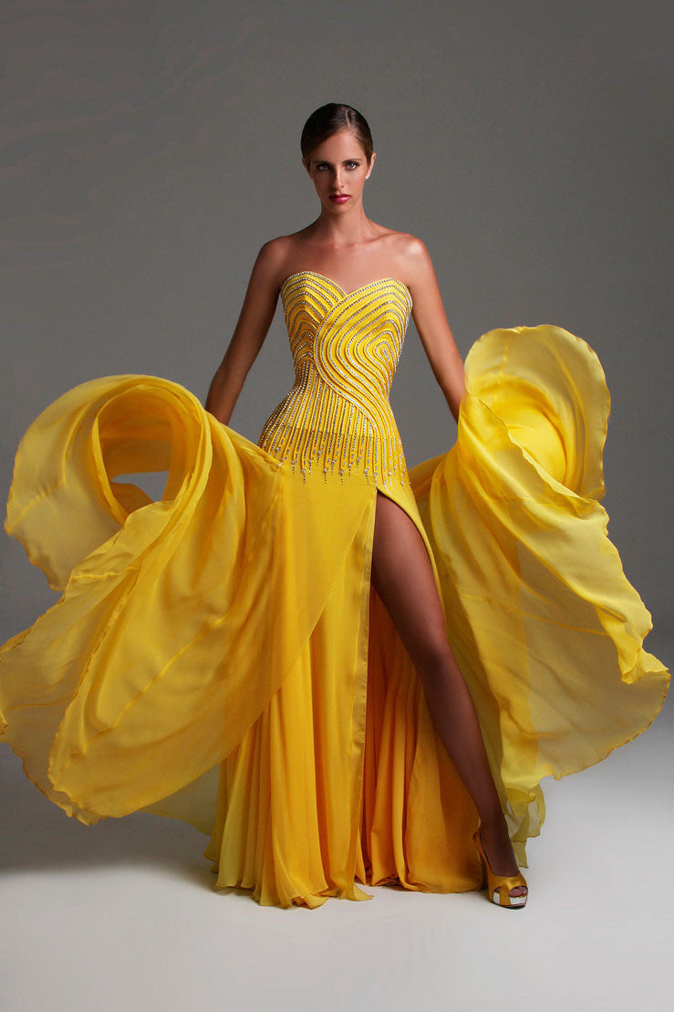 Yellow beaded pageant gown with a dramatic flowing skirt