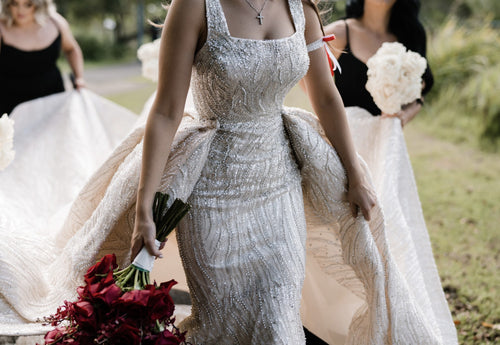 C2023-SD861 - sleeveless open neck line wedding gown with a beaded detachable train