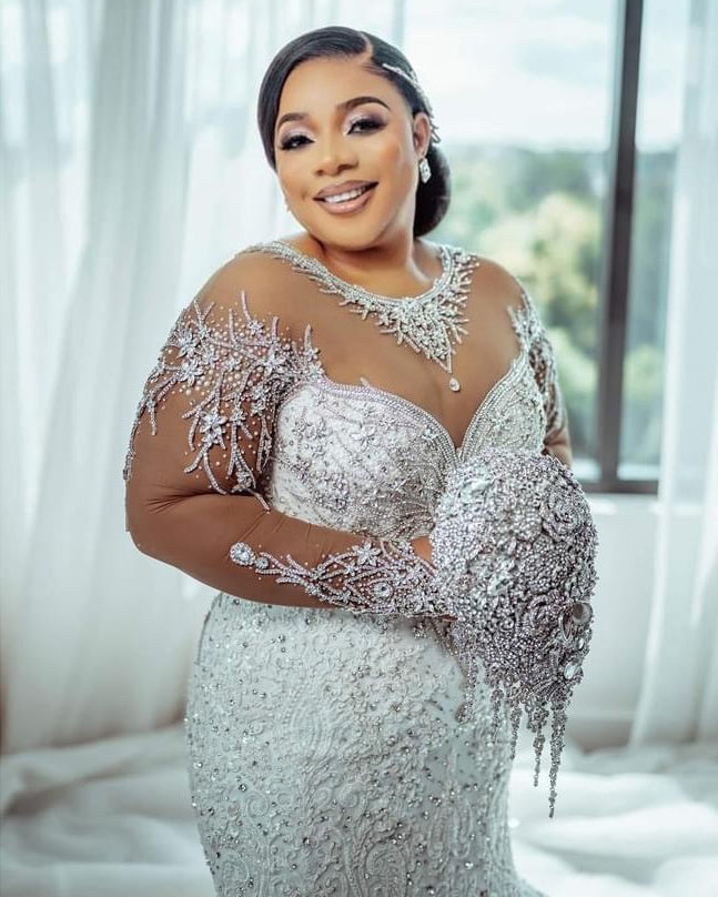 C2026-LA0527 - illusion neckline sheer long sleeve crystal beaded fit-to-flare wedding gown