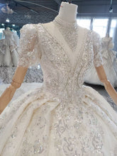 Style 820-16 Short sleeve v-neck beaded wedding gown from DARIUS BRIDAL