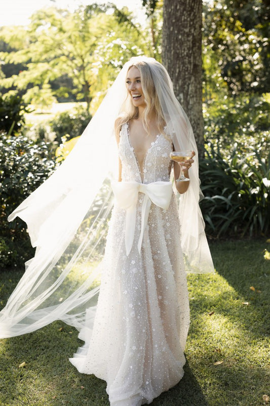 C2022-SV553 - sleeveless sexy deep v-neck wedding gown with bow.