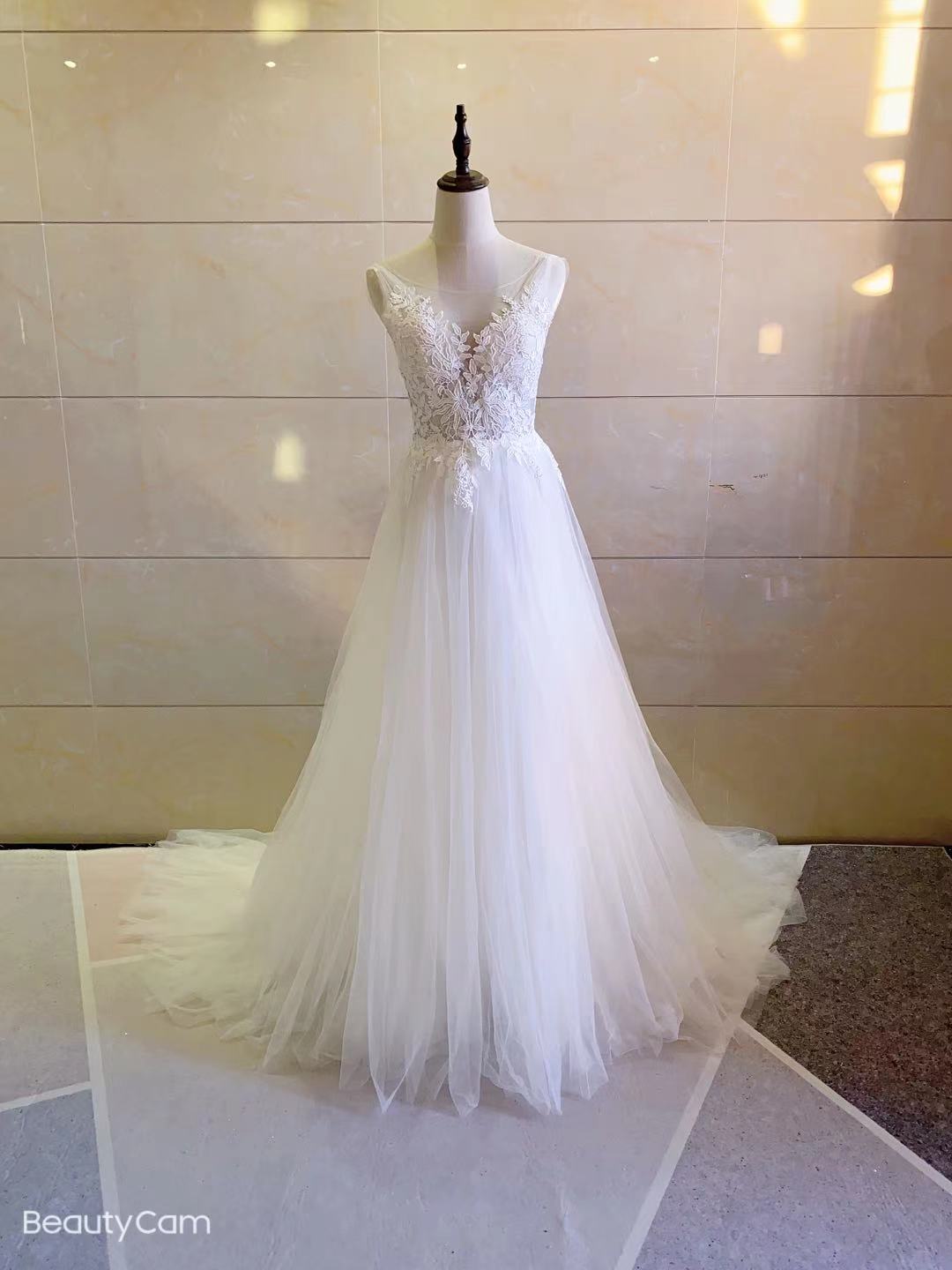 Sleeveless illusion neckline wedding gown
